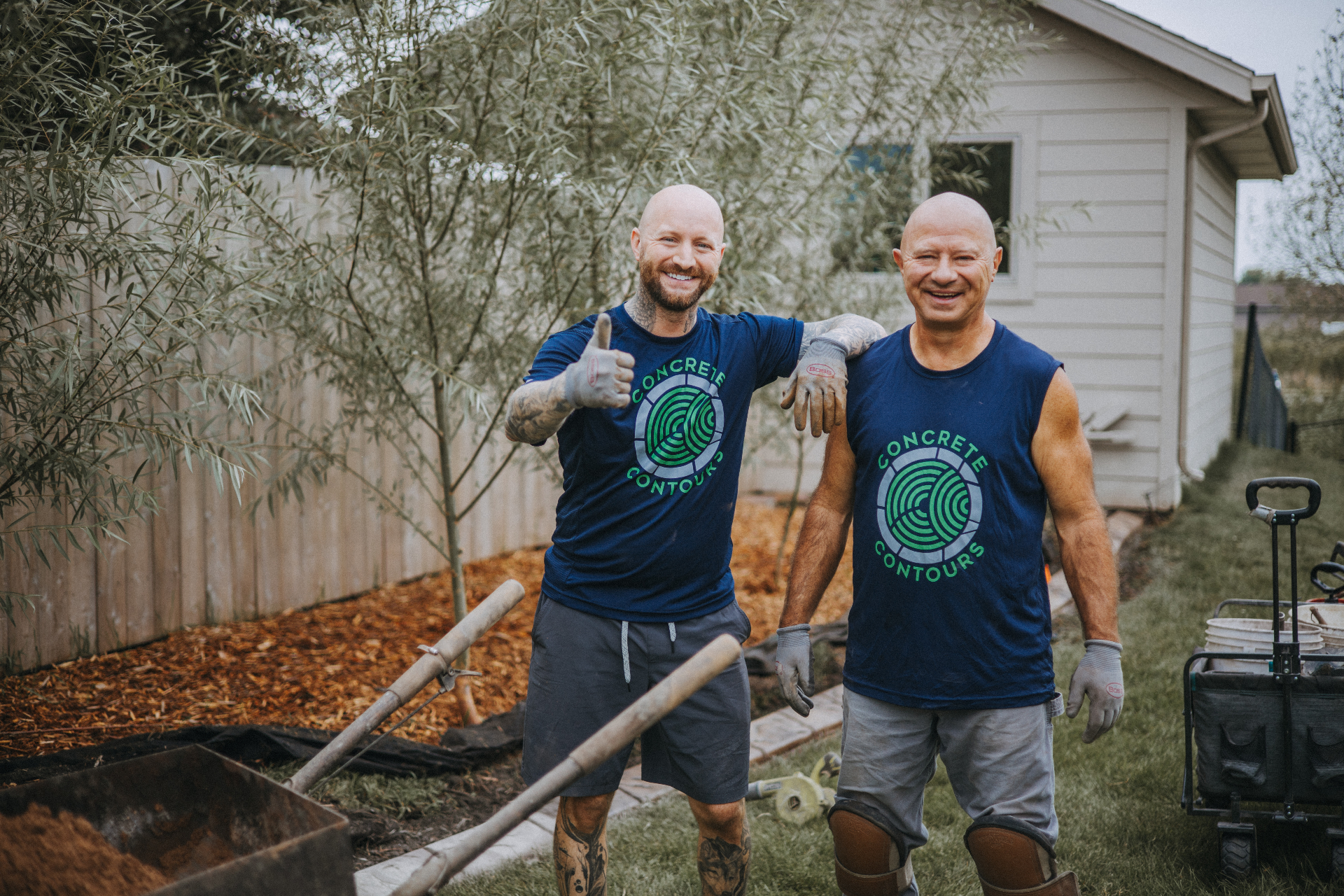The father and son team behind Concrete Contours, in branded shirts on a job site in Sioux Falls